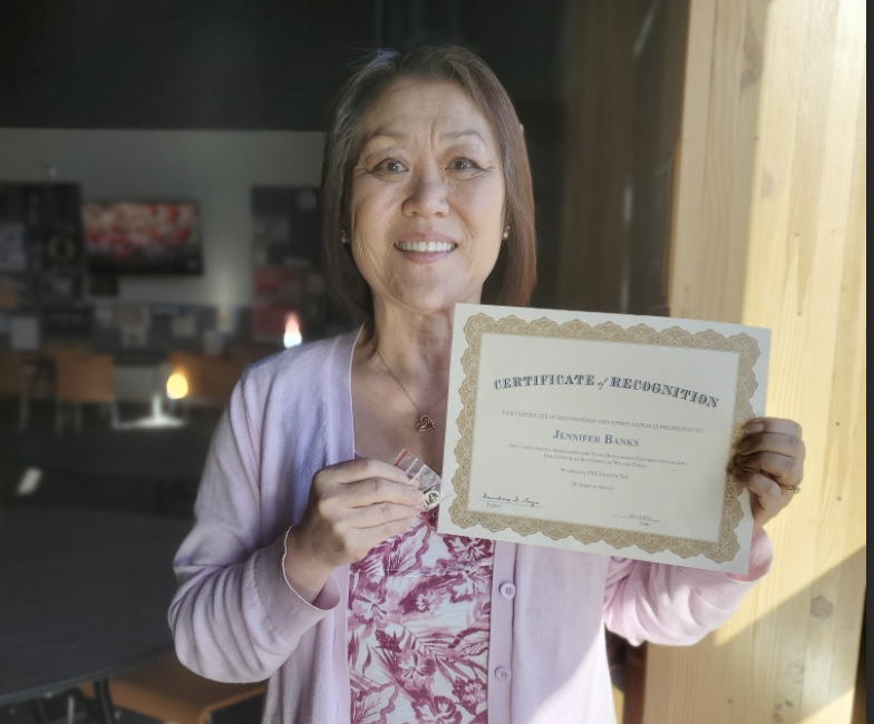 Photo of Jennifer Banks and her certificate.